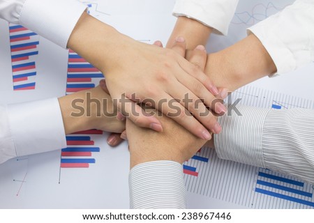 business team putting their hands on top of each other