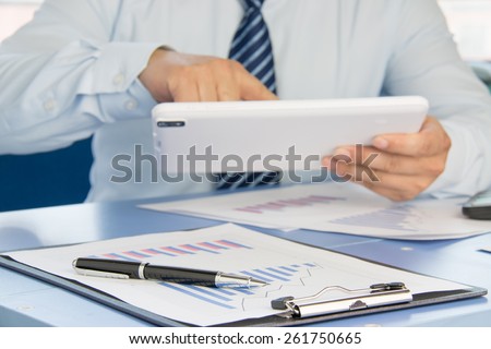 Businessman analyzing financial statements in the office