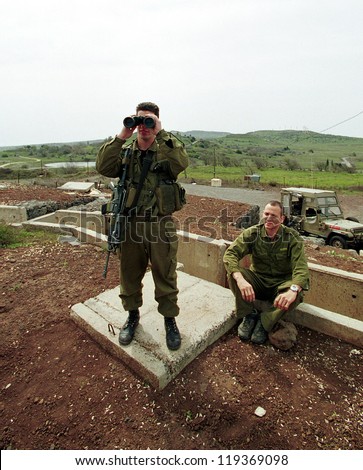 HAR KACHAL, ISRAEL - MARCH 28:  Israeli defense force (IDF) soldiers look over the border into the Syrian village of Kumeitra high into the Golan Heights on March 28, 2000  in Har Kachal, Israel.