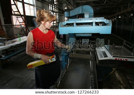 DONETSK - JULY 13: A woman working on a production line at CJSC Vistec in Donetsk, Ukraine, packs welding rods into boxes for shipping on Thursday, July 13, 2006.