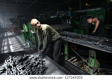 DONETSK - JULY 13: Steel workers create linked chain at the CJSC Vistec steelworks in Donetsk, Ukraine,  on Thursday, July 13, 2006.