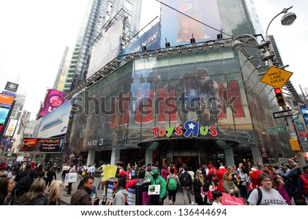 NEW YORK CITY - APRIL 19: People crows in front of the Toys R Us store in Times Square in New York City, on Friday, April 19, 2013.