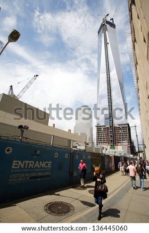 NEW YORK CITY - APRIL 19: Pedestrians walk past the as of yet unfinished World Trade Center in New York City, on Friday, April 19, 2013.