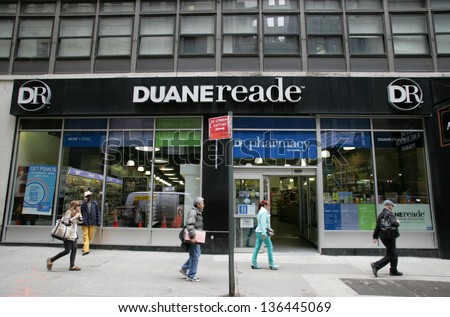 NEW YORK CITY - APRIL 19: Pedestrians walk past a Duane Reade pharmacy and convenience store in New York City, on Friday, April 19, 2013.