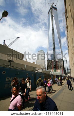 NEW YORK CITY - APRIL 19: Pedestrians walk past the as of yet unfinished World Trade Center in New York City, on Friday, April 19, 2013.