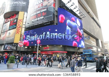 NEW YORK CITY - APRIL 19: Pedestrians walk past a giant sign advertising a Bank of America branch office  in New York City, on Friday, April 19, 2013.