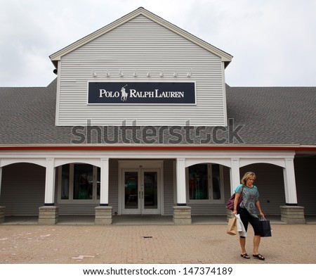 WOODBURY COMMON - JULY 9: Shoppers walk past a Ralph Lauren Polo retail clothing outlet store in Woodbury Common, New York, on Tuesday, July 9, 2013.