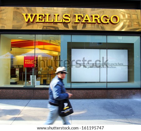 NEW YORK CITY - OCT 24 2013:  Pedestrians walk past a branch office of Wells Fargo & Company bank in Manhattan on Sunday, October 20, 2013.