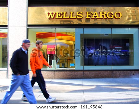 NEW YORK CITY - OCT 24 2013:  Pedestrians walk past a branch office of Wells Fargo & Company bank in Manhattan on Sunday, October 20, 2013.