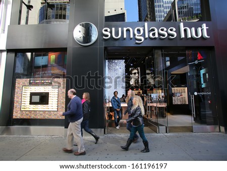 NEW YORK CITY - OCT 23 2013: Pedestrians walk past a Sunglass Hut retail store in New York City on Wednesday, October 23, 2013.