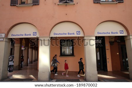 BOLOGNA, ITALY - APRIL 19, 2014: A group of pedestrians walk past a branch office of Deutsche Bank in Bologna, Italy, on Saturday, April 19, 2014.