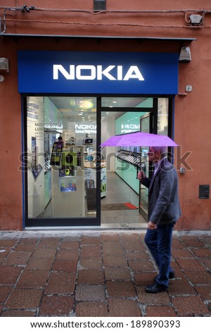 BOLOGNA, ITALY - APRIL 19, 2014: A man walks past a Nokia mobile telephone retail store in Bologna, Italy, on Saturday, April 19, 2014.