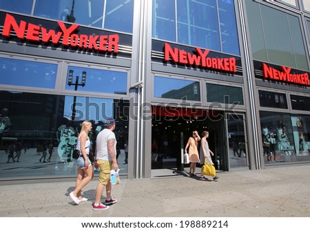 BERLIN, GERMANY - JUNE 11, 2014: Pedestrians walk past a NewYorker clothing store in  Berlin, Germany, on Saturday, June 11, 2014.
