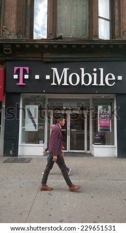 NEW YORK CITY - OCT. 20, 2014: Pedestrians walk past a T-Mobile retail store in New York City. T-Mobile is an international mobile communications company.