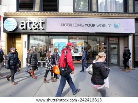 NEW YORK CITY - MONDAY, DEC. 29, 2014: Pedestrians walk past an AT&T mobile telephone store. AT&T Mobility, formerly known as Cingular Wireless, is a wholly owned subsidiary of AT&T