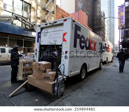 NEW YORK CITY - FEB. 25, 2015:  FedEx drivers unload two delivery vans in midtown Manhattan. FedEx Corporation is an American global courier delivery services company