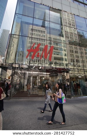 NEW YORK CITY - FRIDAY, MAY 8, 2015: Pedestrians walk past a H&M clothing retail store in Manhattan. H & M Hennes & Mauritz AB (H&M) is a Swedish multinational retail-clothing company.