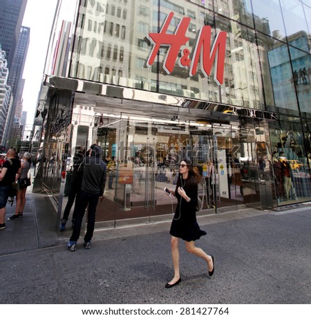NEW YORK CITY - FRIDAY, MAY 8, 2015: Pedestrians walk past a H&M clothing retail store in Manhattan. H & M Hennes & Mauritz AB (H&M) is a Swedish multinational retail-clothing company.