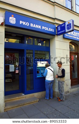 KRAKOW, POLAND, 25 OCTOBER 2003 -- A customer withdraws money from a Bank PKO BP automated teller cash machine. Bank PKO is one of Poland\'s leading financial institutions.