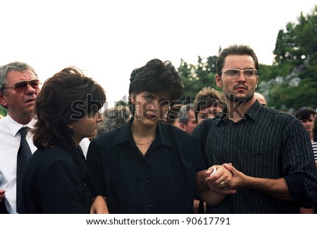 VAKUF, BOSNIA - AUG 17: A woman in comforted by her family after the funeral for her fallen soldier husband in Gornji Vakuf, Bosnia, on Tuesday,  August 17, 1993.