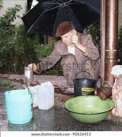 SARAJEVO, BOSNIA - OCT 24: A man desperately tries to collect rain water to drink  in Sarajevo, Bosnia, on Friday, October 24, 1993.  Sarajevo has been under siege for more than one year.