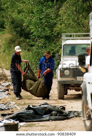 SREBRENICA, BOSNIA - JUNE 12: United Nations forensic experts unearth victims from a mass grave. The victims are among the estimated 8000 civilians killed by Bosnian Serb soldiers in July 1995 on June 12, 1996 in Srebencia, Bosnia.