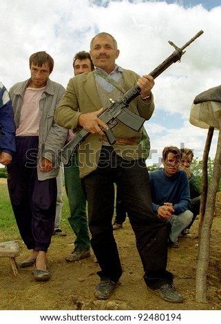 RUDNIK, KOSOVO - JULY 9:  Kosovo Liberation Army (KLA) fighters pause during heavy fighting with Serb security forces for the strategic city of Pec on July 9, 1998 in Rudnik, Kosovo