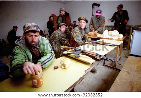 RETMILJE, KOSOVO 10 NOVEMBER 1998 -- Soldiers of the Kosovo Liberation Army (KLA) eat peanut butter at a KLA regional HQ and barrack  in the Drenica Triangle.