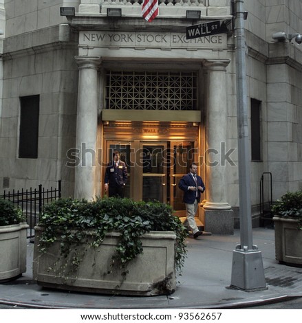 NYC - OCT 31: Two off-duty brokers stand by a back entrance to the New York Stock Exchange on Wall Street in New York City on Friday, October 31, 2008.