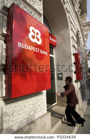 BUDAPEST, HUNGARY - OCT 20: A woman walks into a Budapest Bank branch in Budapest, Hungary, on Monday, October 20, 2008. General Electric Capital Services (GEC), a unit of General Electric Co, is the majority owner.
