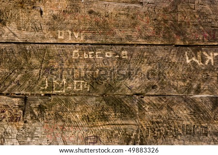 old pub table with messages carved in it