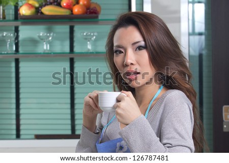 Beautiful housewife preparing food, coffee and bread.