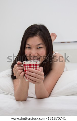Coffee woman in bed. Woman in bed drinking coffee in the morning. Isolated on white background.