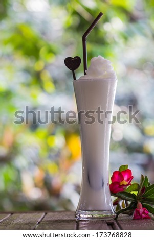 a glass cocktail of coconut milk ice smoothie, tropical fruit