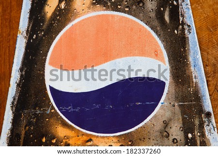 BANGKOK, THAILAND - MARCH 11, 2014: Close up old Pepsi logo printed on vintage enamel tag. Pepsi is a carbonated soft drink produced by PepsiCo, created in 1893 and introduced as Brand\'s Drink