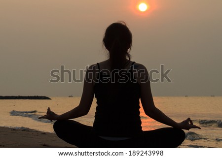 portrait back view of Asian woman practicing yoga at peace sea in morning