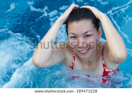 Asian woman enjoy and relaxing in spa pool on vacation
