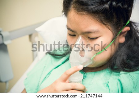 children patients on bed with oxygen mask in hospital