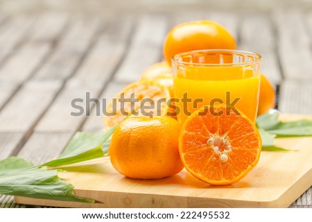 orange Juice and orange on the cutting board