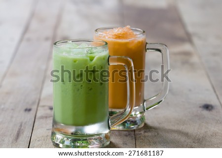 Ice green tea and milk tea in glass place on wooden