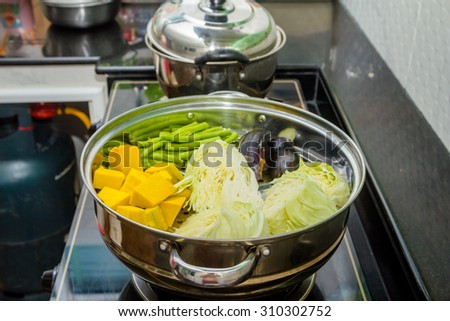 Pumpkin, cabbage, beans, eggplant in steaming pot
