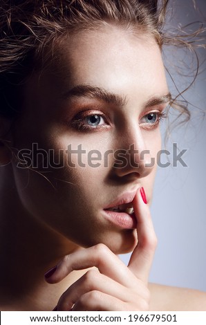 beautiful portrait of the young girl with a natural natural make-up, big eyes and chubby lips, velvet skin