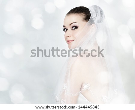 Beautiful brunette woman as bride with long white veil-sexy portrait