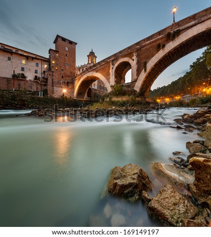 Fabricius Bridge and Tiber Island at Twilight, Rome, Italy.  This is the oldest Roman bridge in Rome, still existing in its original state from 62 BC, built by Lucius Fabricius.