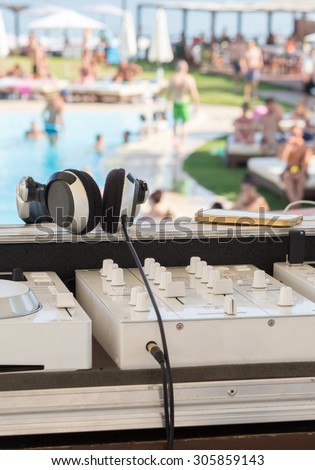 White Dj mixer on a swimming pool party