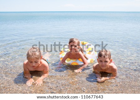 Three children have the water-based recreation on Black sea, Crimea, Ukraine