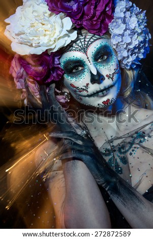 attractive young woman with sugar skull makeup