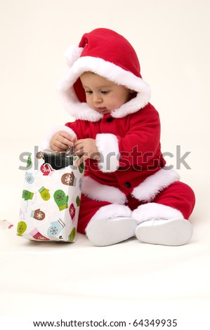 Baby Opening First Present on White Background.