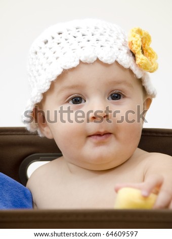 Cute Baby in a Box with a Crochet Hat.