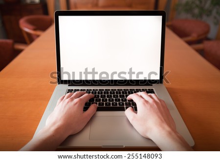 Man hands using, working on laptop with blank screen in home living room. first person view.